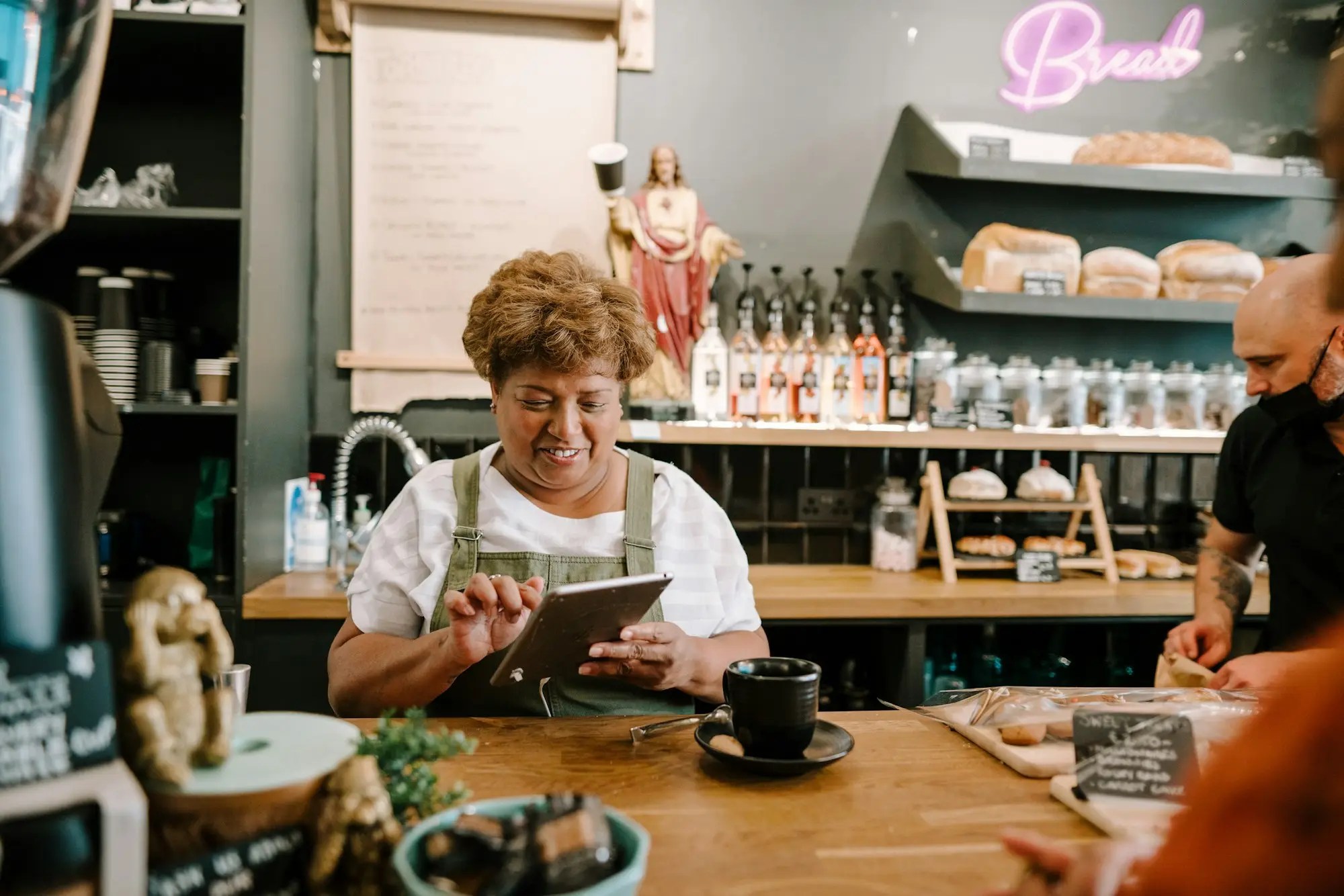 Café owner checking stock at the counter