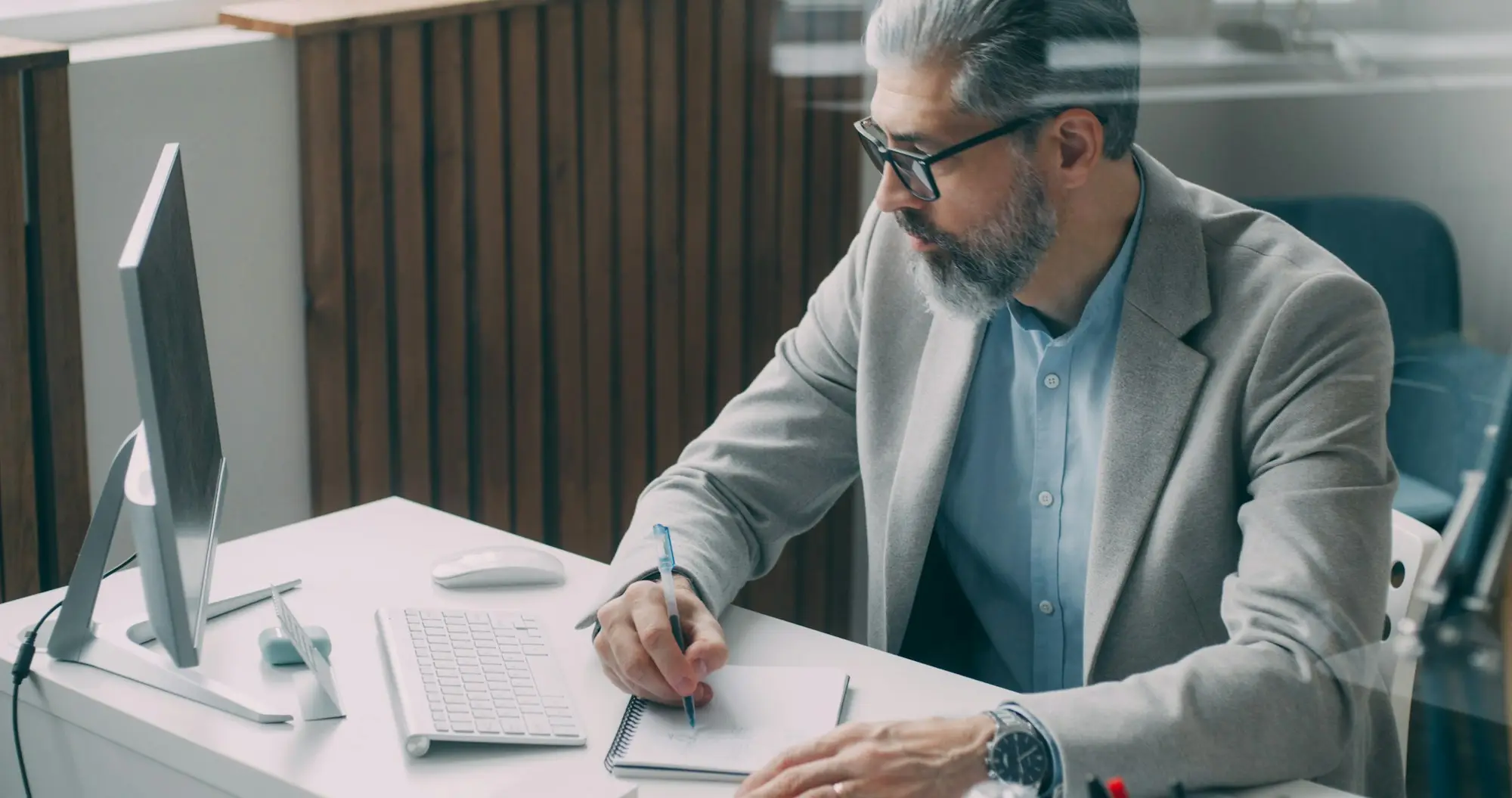 Man writing notes at his desk